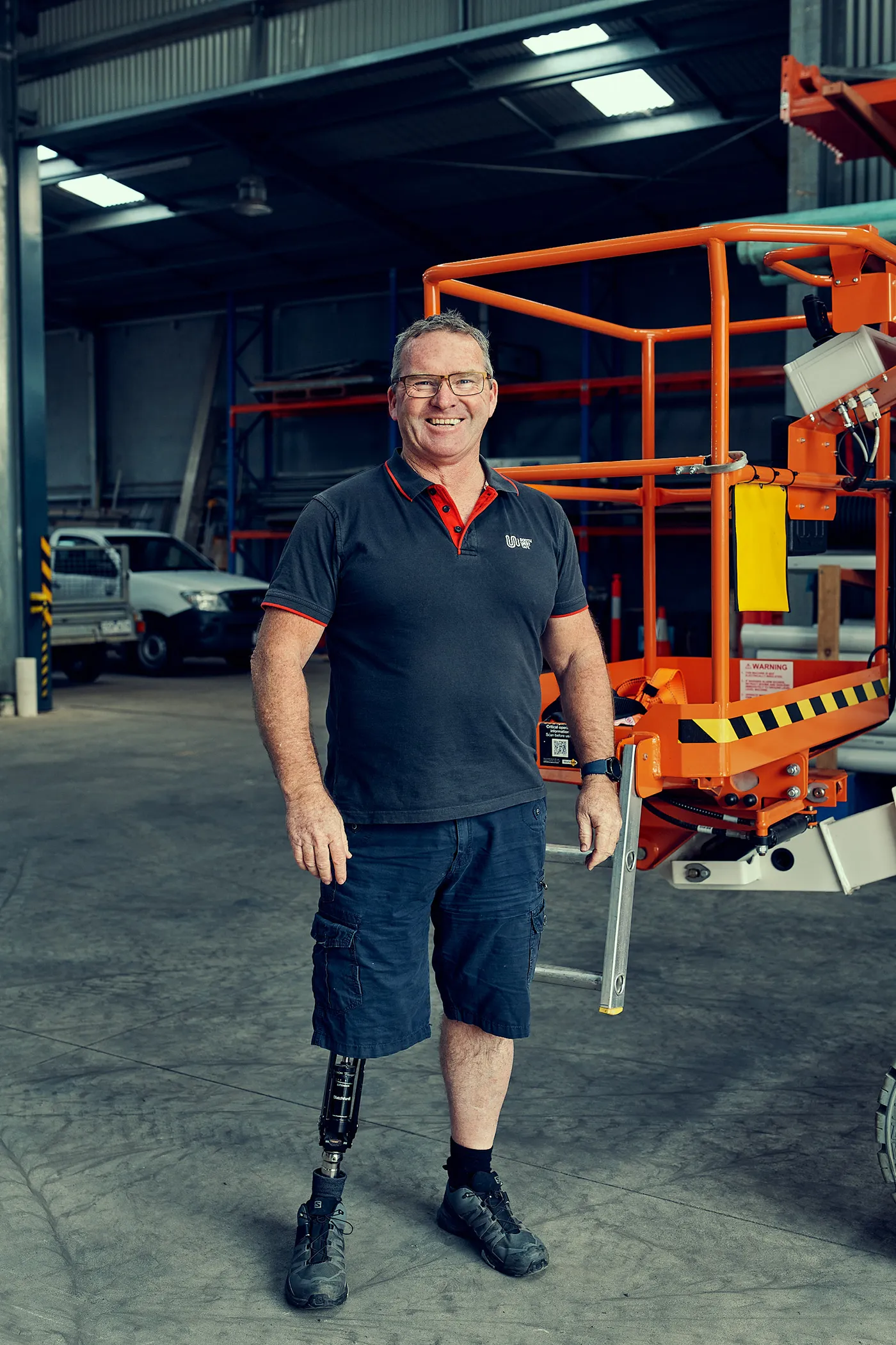 Man with a prosthetic leg at an industrial workplace